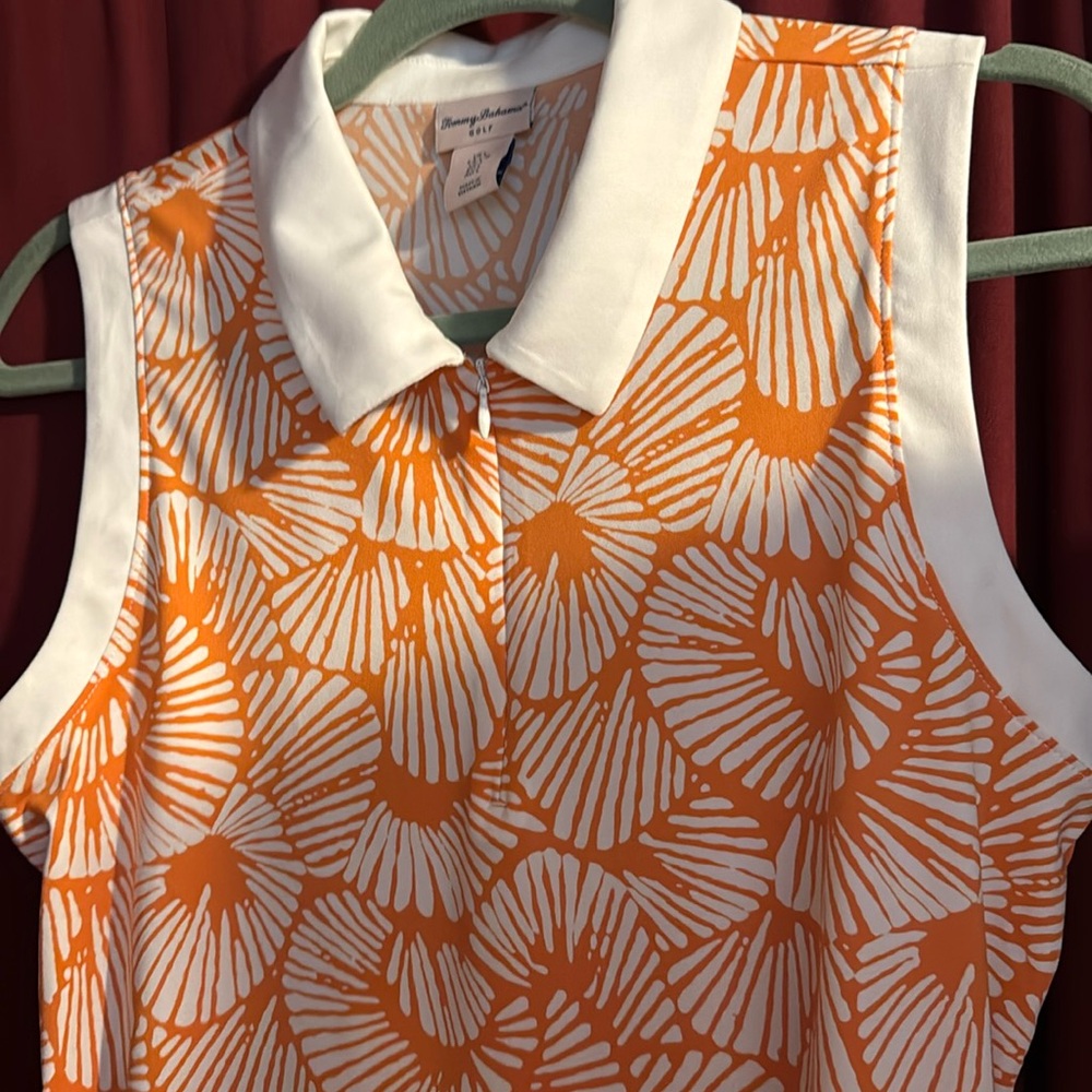 Tommy Bahama gently used orange starburst golf top, size large.